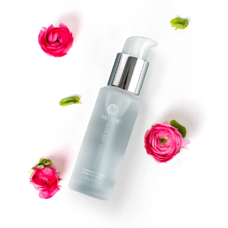 Neora’s Advanced SIG-1273 Concentrated Serum bottle amid a rose bouquet